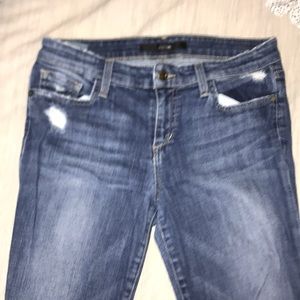 Slightly worn ripped blue jeans